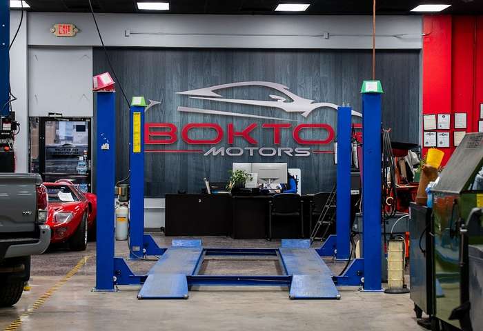 Vehicle lift and Boktor Motors branding inside the service center